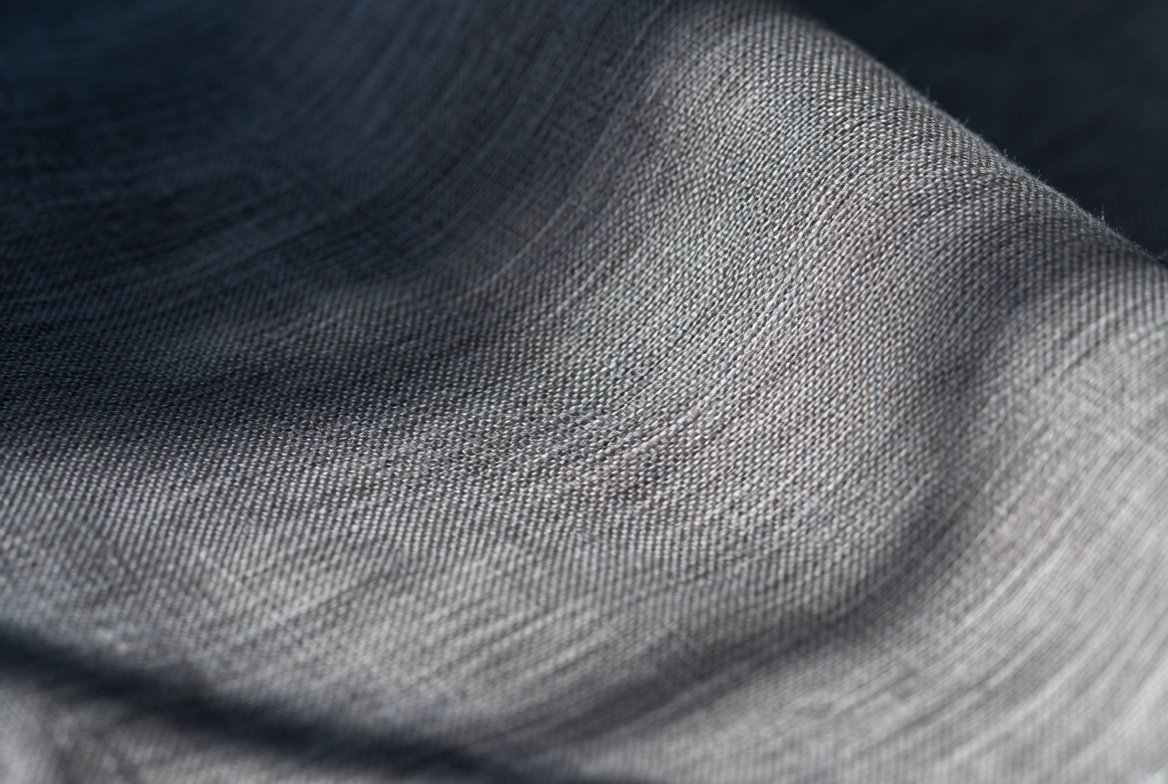 Close-up of fabric and stitching on a garment flat
