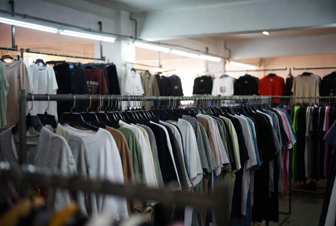Rail of hanging garments in a Singapore wholesale showroom
